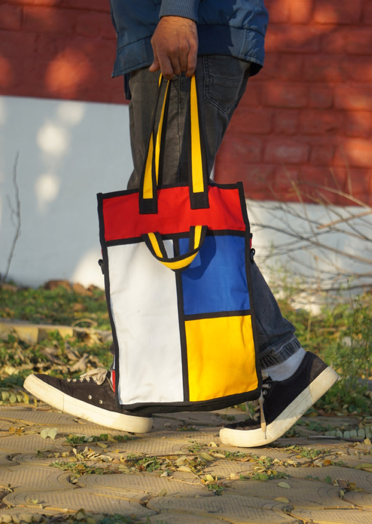 Godewyn Expandable Tote Bag - Sturdy Canvas Construction and Piet Mondrian Inspiration. Close-up of the Godewyn expandable tote bag's sturdy canvas construction, infused with Piet Mondrian's colorblock art inspiration. The bag's durable materials and artistic design combine fashion with functionality