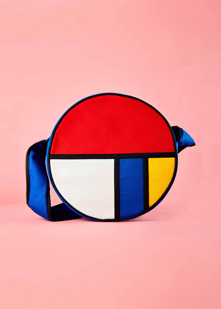 Francisca Moon Shaped Sling Bag - Piet Mondrian Colorblock Design" Alt text: "Front view of the Francisca moon-shaped sling bag, showcasing a striking colorblock pattern inspired by Piet Mondrian's art. The bag features geometric shapes and bold primary colors, exuding a fusion of artistic expression and modern functionality.