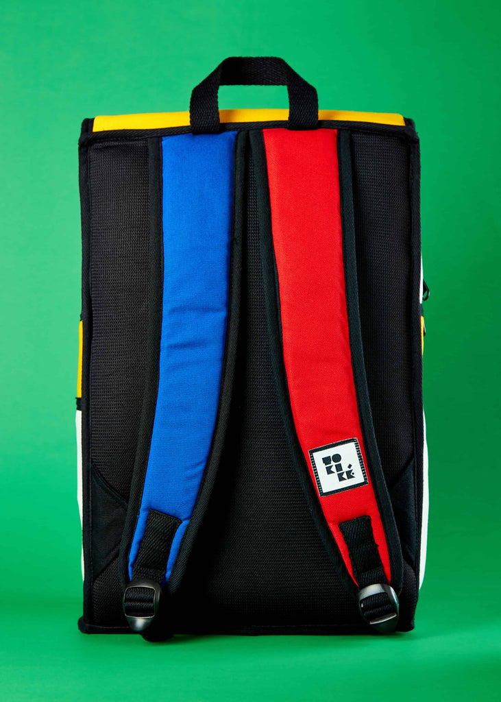  Reizen Travel Backpack - Versatile and Stylish Travel Companion"    A lifestyle shot highlighting the Reizen travel backpack in use, offering versatility and stylish functionality. The Piet Mondrian colorblock art adds an artistic touch to this reliable travel companion.