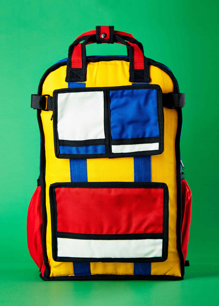 Pieter Designer Travel Backpack - Piet Mondrian Colorblock Art" Front view of the Pieter designer travel backpack, featuring a vibrant colorblock art inspired by Piet Mondrian. This canvas backpack is thoughtfully designed for one-day trips with family and friends, combining style and functionality.