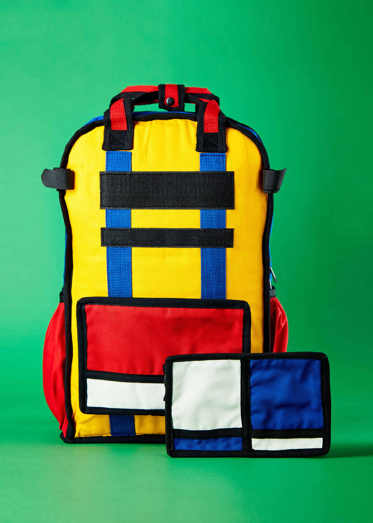 Embrace Artistic Adventure with Pieter Travel Backpack"   "An image capturing the spirit of adventure with the Pieter travel backpack, inviting users to embrace their artistic side while exploring the world. The backpack's inspired Piet Mondrian colorblock art sets it apart as a statement piece for your journeys