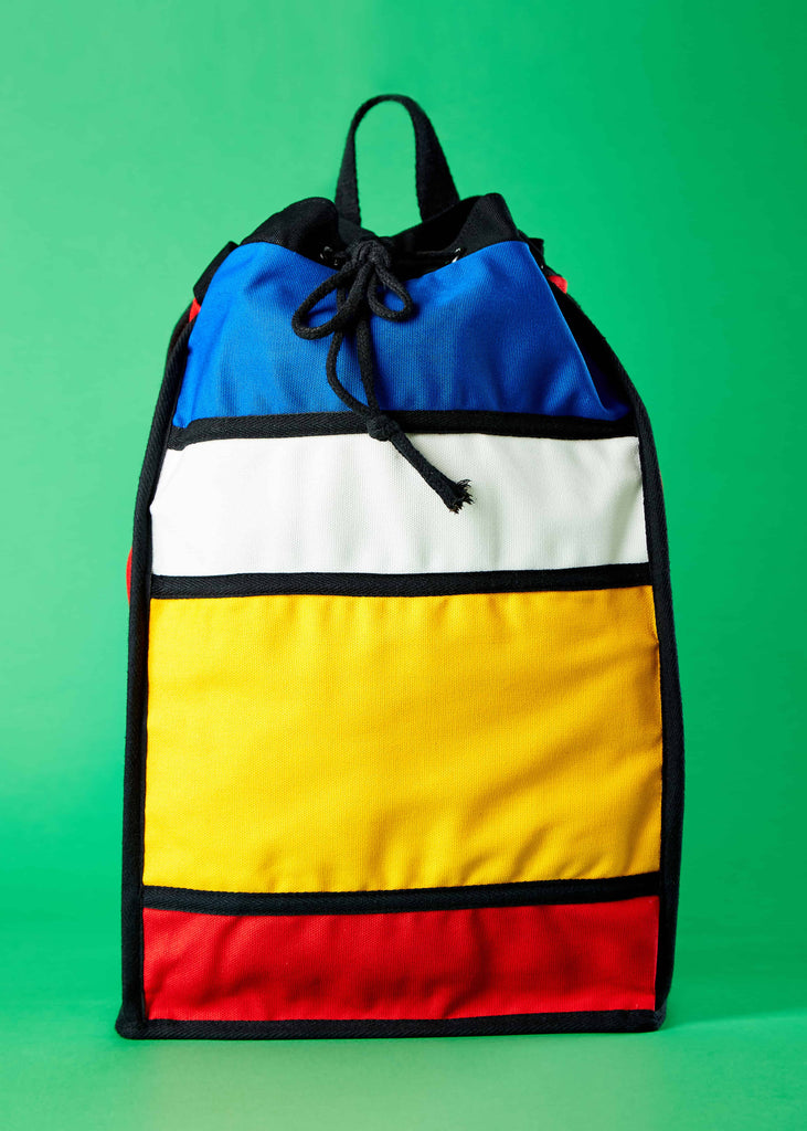 Soelaas Designer Travel Drawstring Backpack - Piet Mondrian Colorblock Art"     Front view of the Soelaas designer travel drawstring backpack, showcasing a captivating Piet Mondrian-inspired colorblock art design. This canvas backpack combines artistic elegance with practicality for your travel needs.